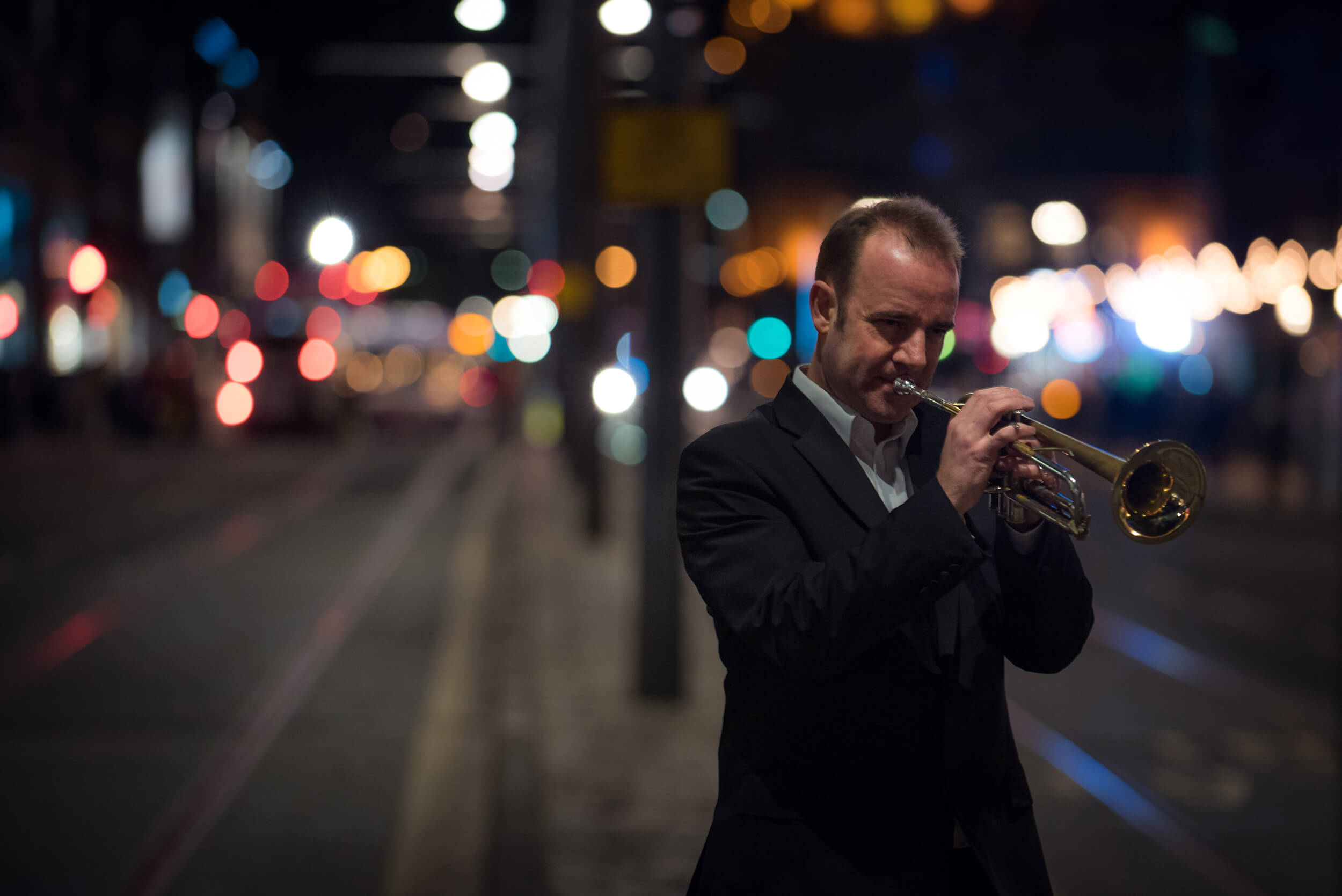 Artist playing trumpet on street