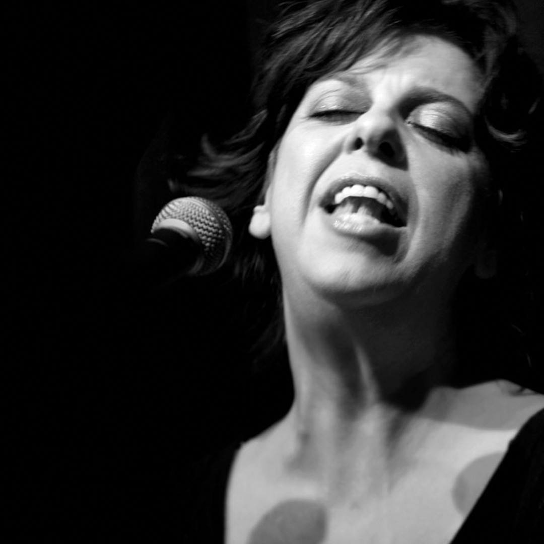A black and white image of Liane singing